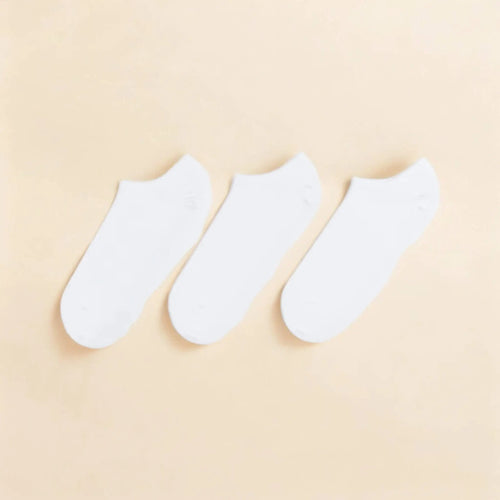 Three white cotton ankle socks arranged neatly on a soft beige background ankle socks 3 pack