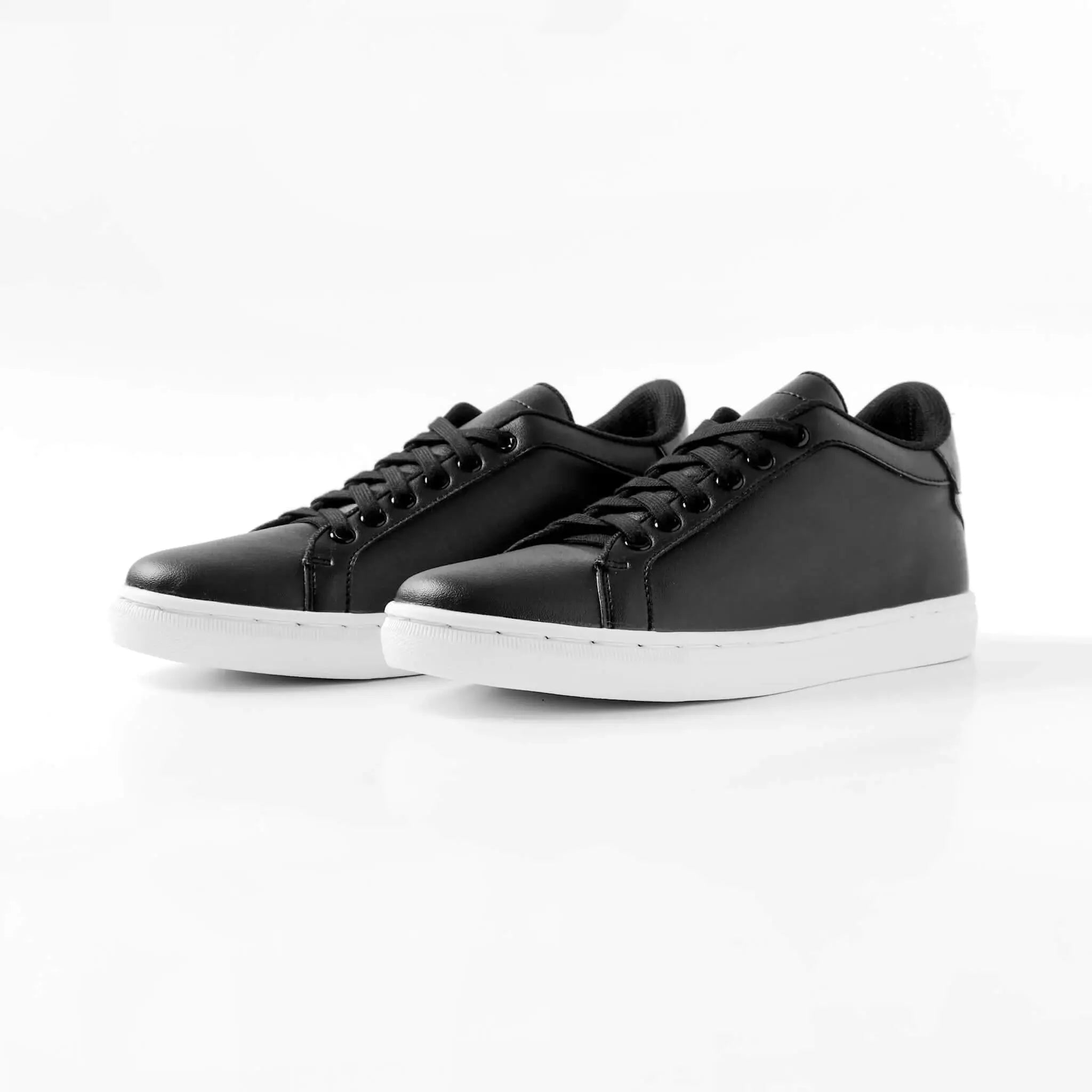 Pair of Mercury Black elevator sneakers. Premium vegan leather height increasing shoes with invisible 2 inch lift.