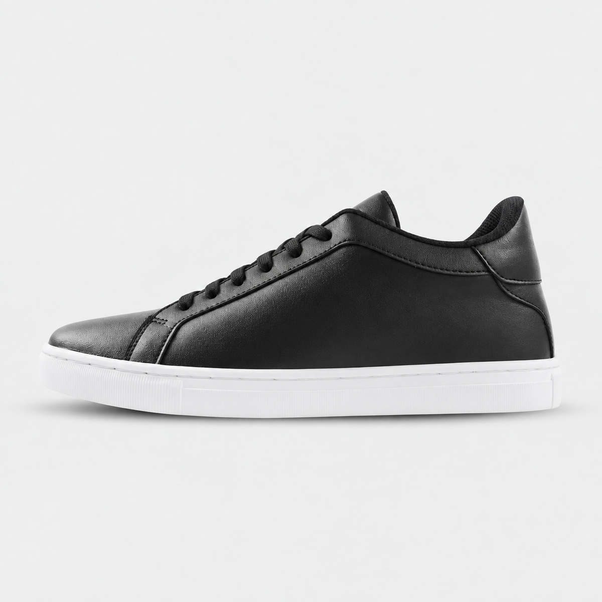 Side view of Kosen Mercury Black elevator sneakers with a black upper and white soles.