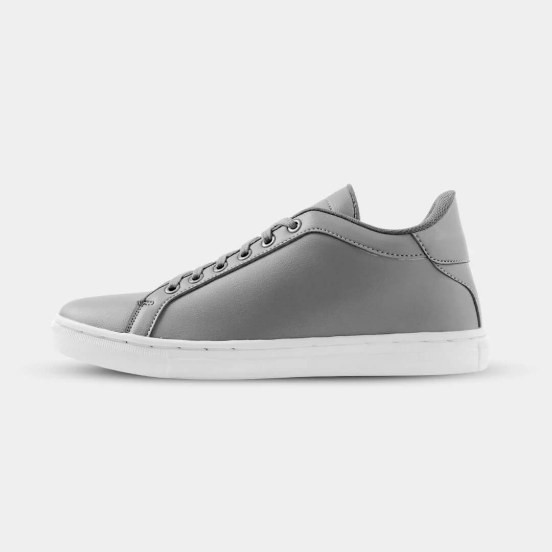 Side view of Mercury Gray elevator sneakers. Minimalist gray height increasing shoes with white soles.