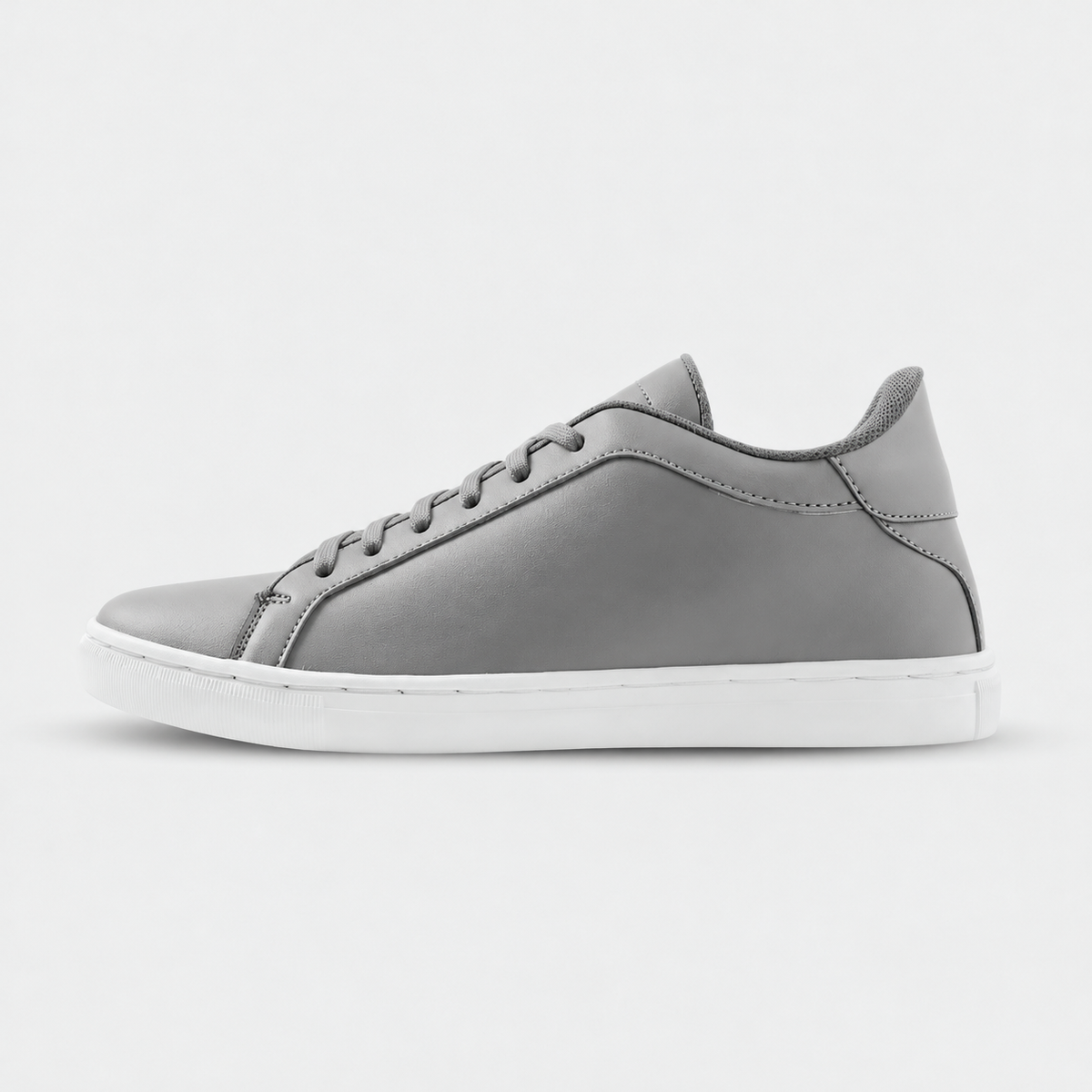 Side view of Mercury Gray elevator sneakers. Minimalist gray height increasing shoes with white soles.