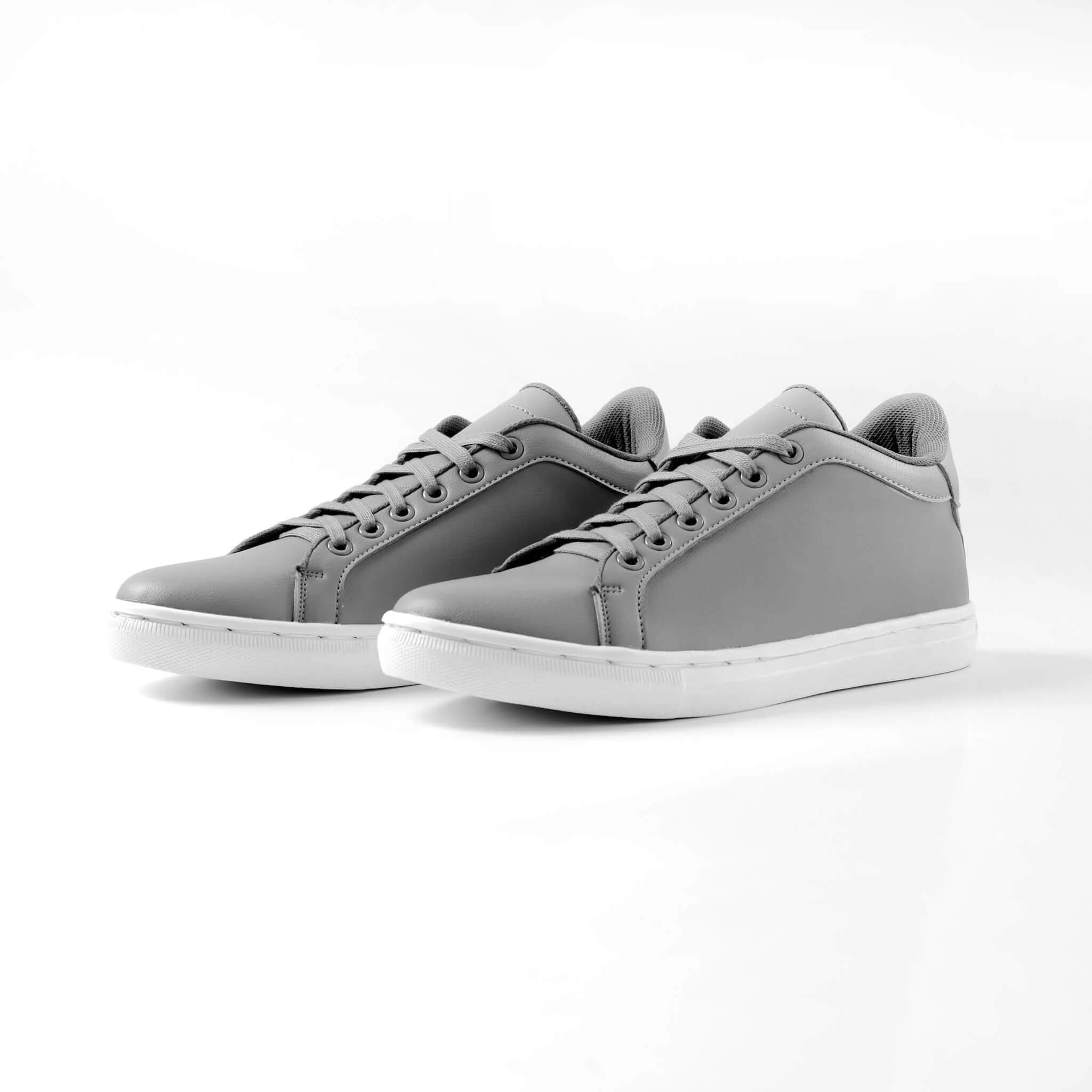 Pair of Mercury Gray elevator sneakers. Premium synthetic leather height increasing shoes for men.