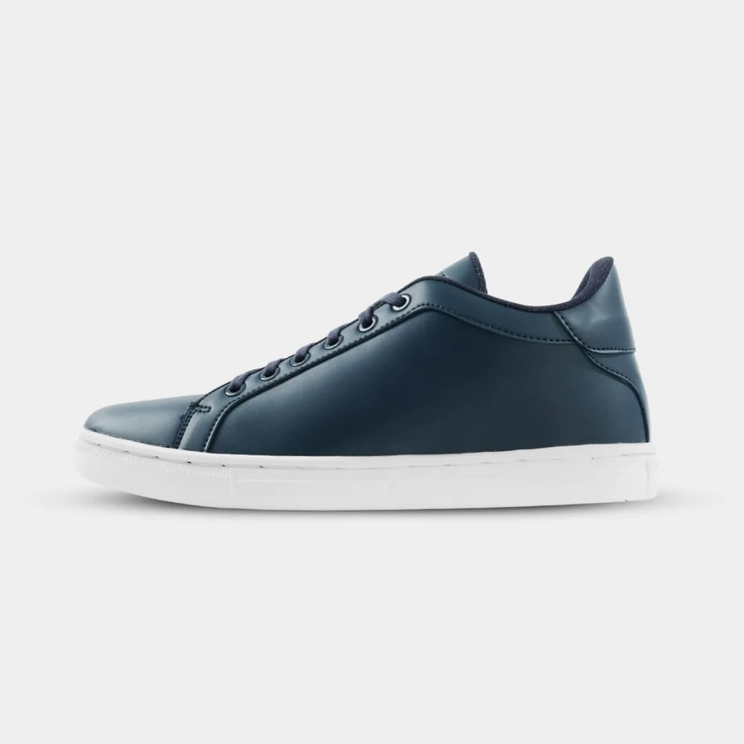 Side view of Mercury Navy elevator sneakers. Blue synthetic leather height increasing shoes with white soles.