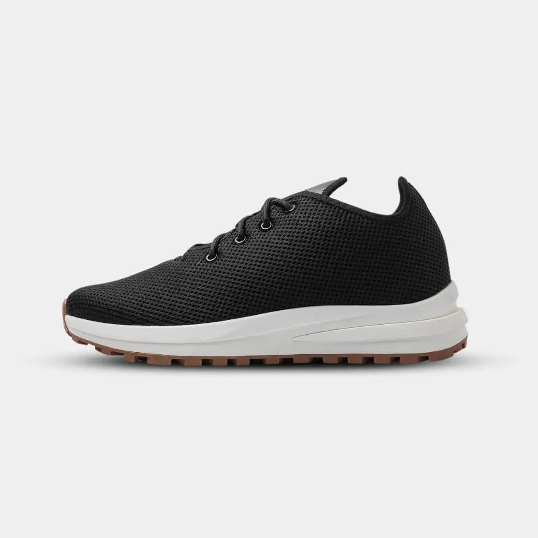 Side view of Venus Black elevator sneakers. Breathable knit height increasing shoes with athletic fit.