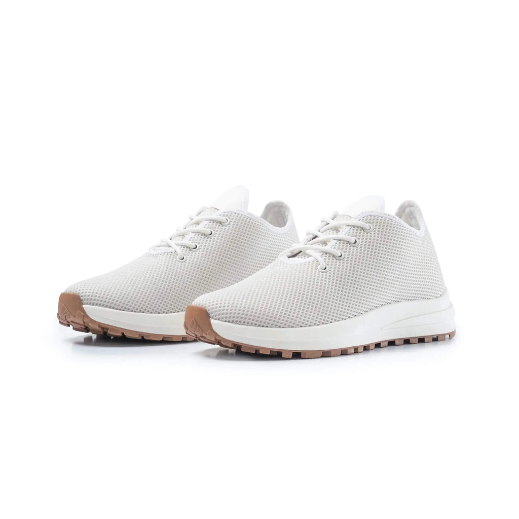 Pair of Venus White elevator sneakers. Lightweight white knit height increasing shoes with gum soles.